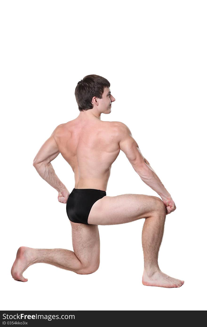 The young body builder poses with greater muscles on a white background