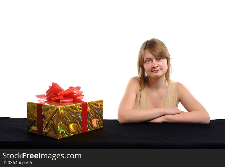 A young rather serious woman with a gift on a white background. A young rather serious woman with a gift on a white background