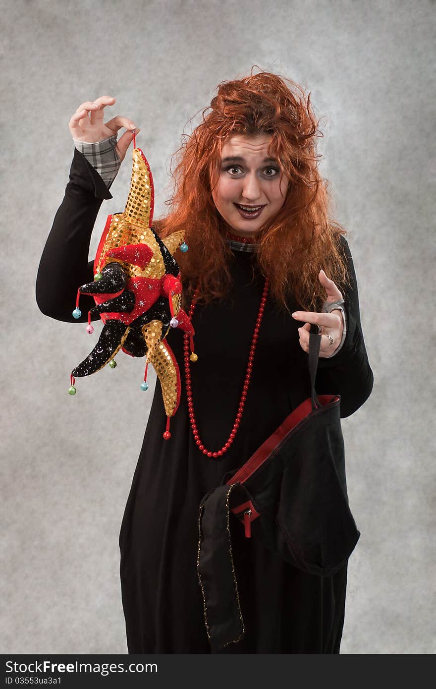 Crazy young woman with tousled hair and other items in the hands of