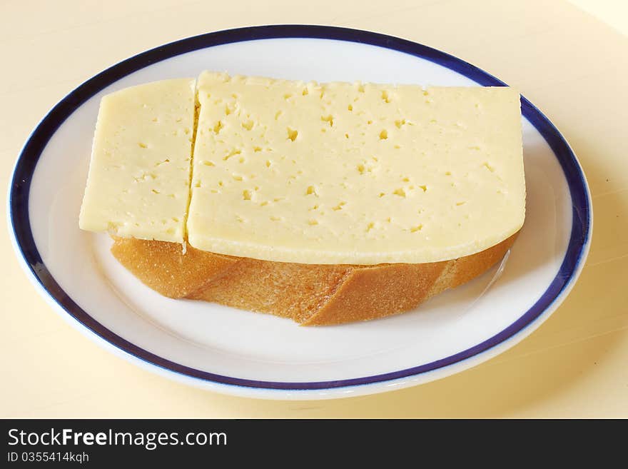 Bread and cheese on a ceramic plate. Bread and cheese on a ceramic plate.