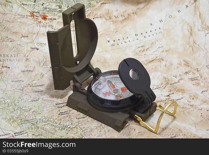 A compass sitting in a light box on a map. A compass sitting in a light box on a map.