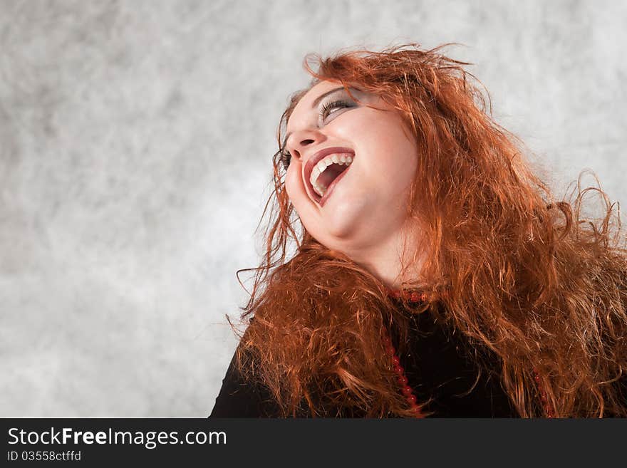 Crazy young woman with matted hair, his head thrown back laughing. Crazy young woman with matted hair, his head thrown back laughing