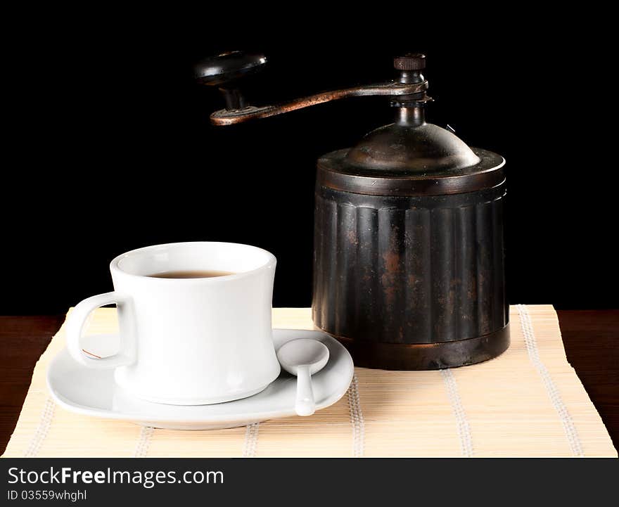 A cuo of coffee with vintage grinder. Studio shot. A cuo of coffee with vintage grinder. Studio shot.