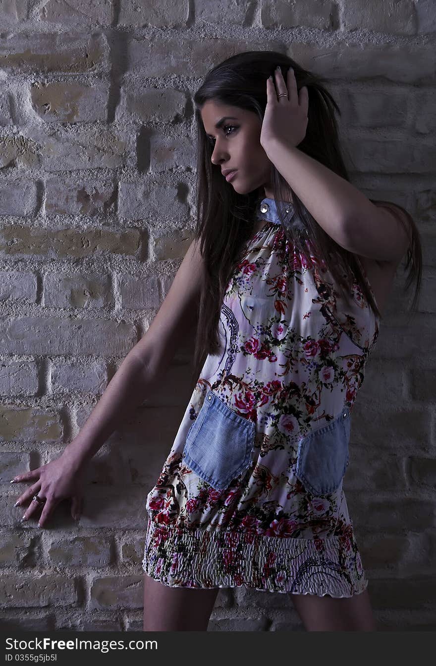 Young woman on brick wall background. Photo. Young woman on brick wall background. Photo.