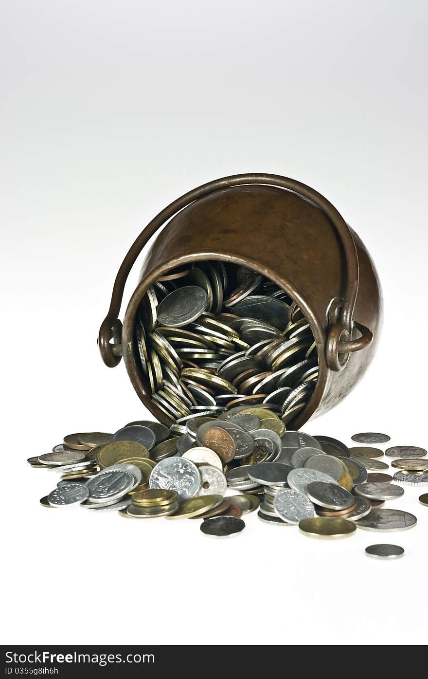 Old copper pot with coins on white. Old copper pot with coins on white