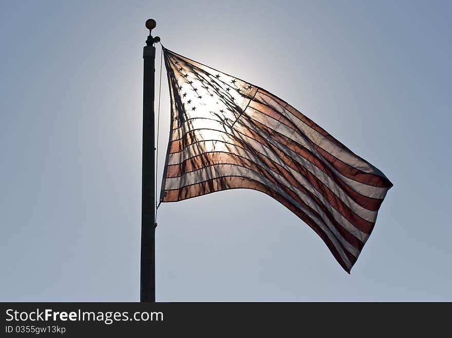 Morning sun shining through the American flag. Morning sun shining through the American flag