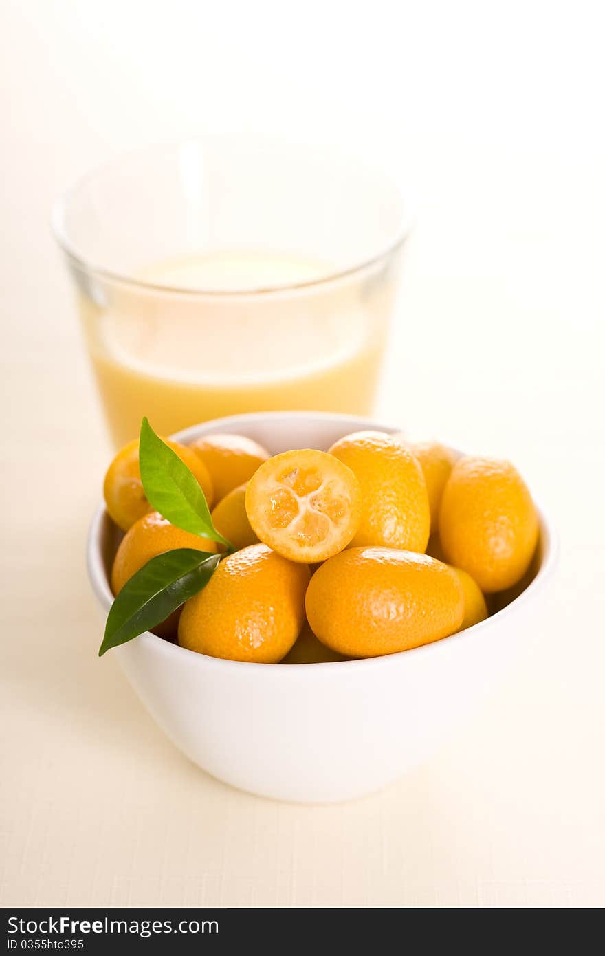 Kumquat small orange fruits on brown background