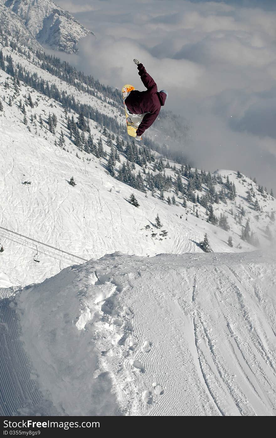 Jumping freestyle snowboarder