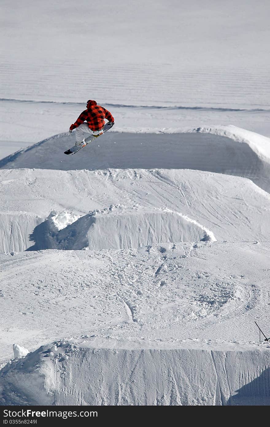 Jumping freestyle snowboarder