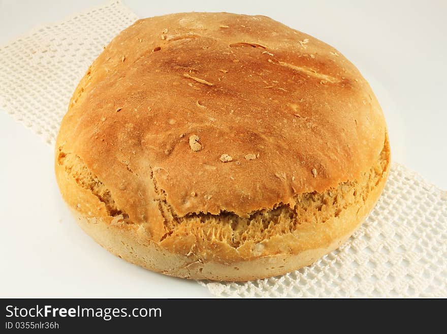 Freshly home-made bread on a knitted cloth, handmade. Freshly home-made bread on a knitted cloth, handmade