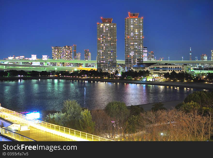 Two high rise buildings in Tokyo is shot from Odaiba Island, beautiful reflection can be seen on the water of the Tokyo Bay. Two high rise buildings in Tokyo is shot from Odaiba Island, beautiful reflection can be seen on the water of the Tokyo Bay