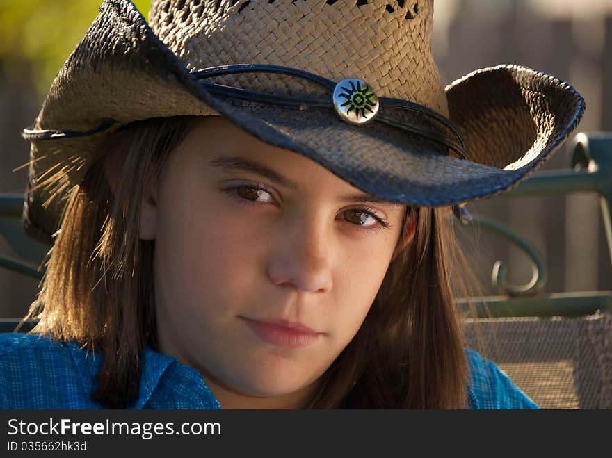 Head shot of young girl with brown eyes in cowboy hat and western wear. Head shot of young girl with brown eyes in cowboy hat and western wear