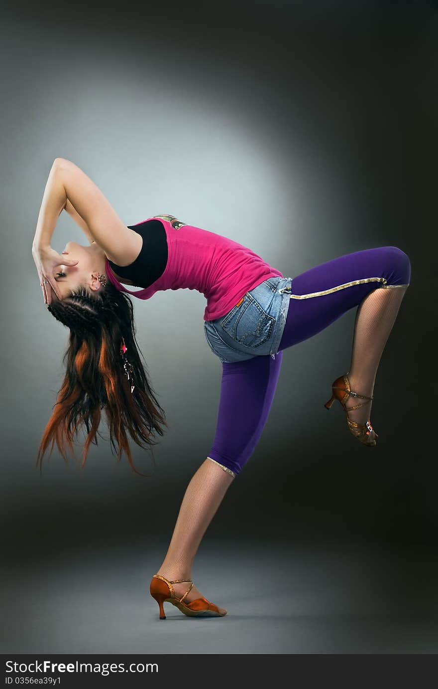 Cool dancer woman on gray background