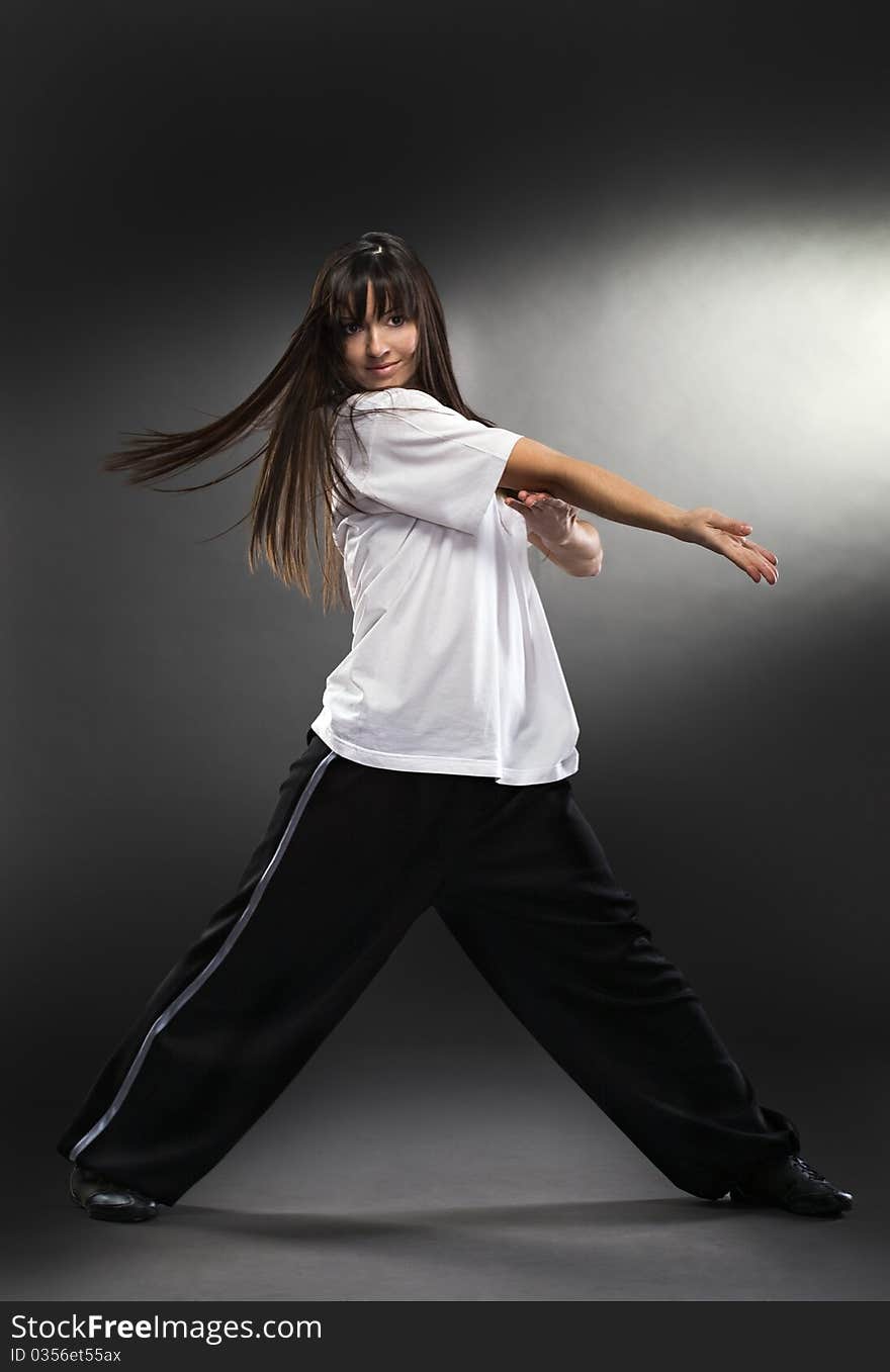 Cool dancer woman on gray background