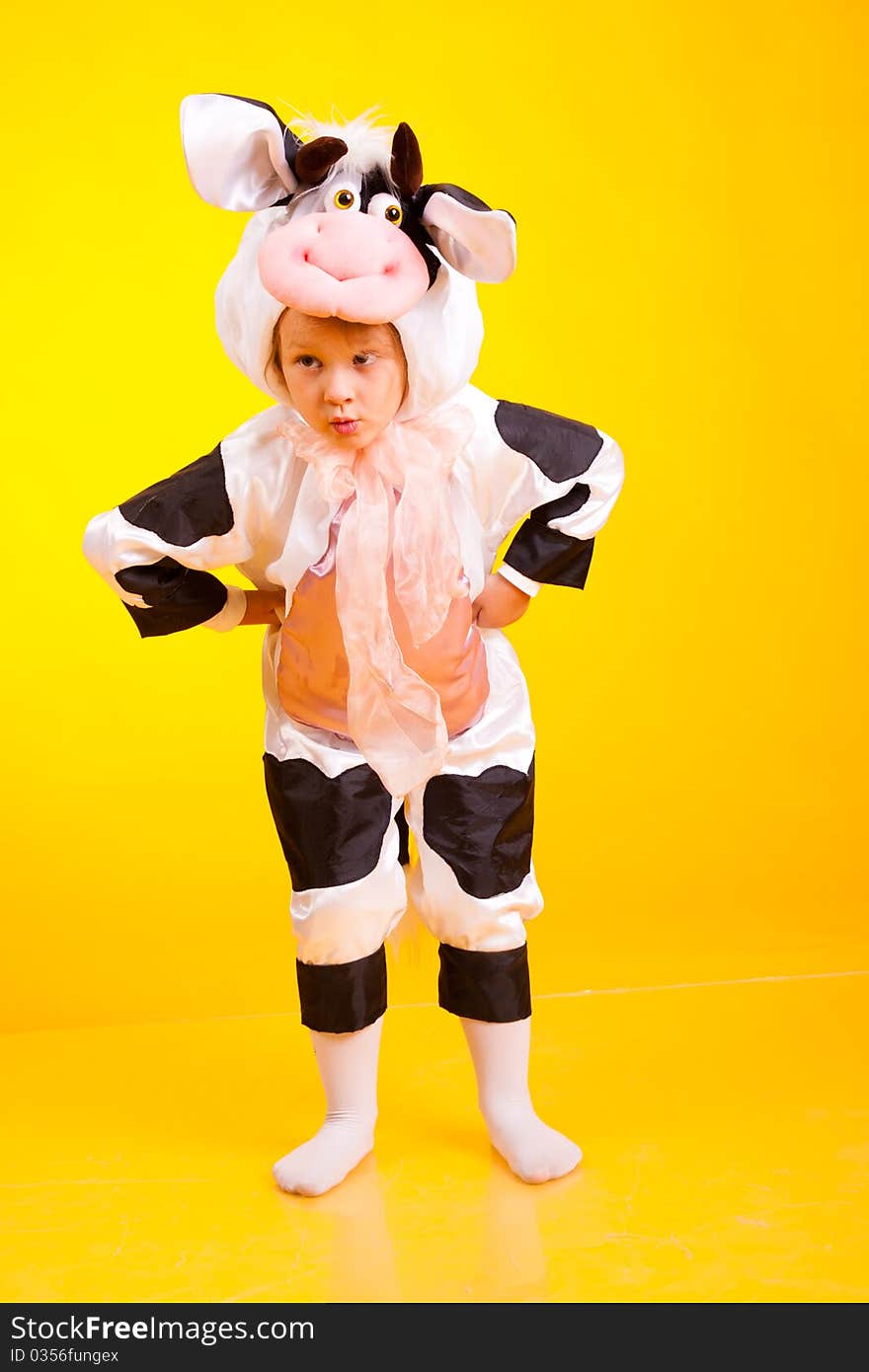 Little girl in the suit of cow