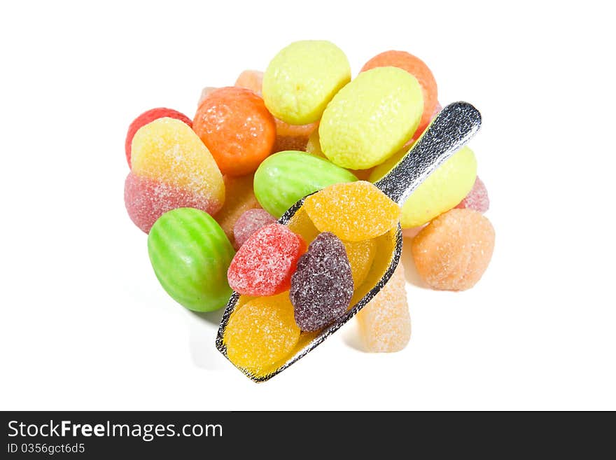 Multi-colored sweets and chewing gums on white backgrounds