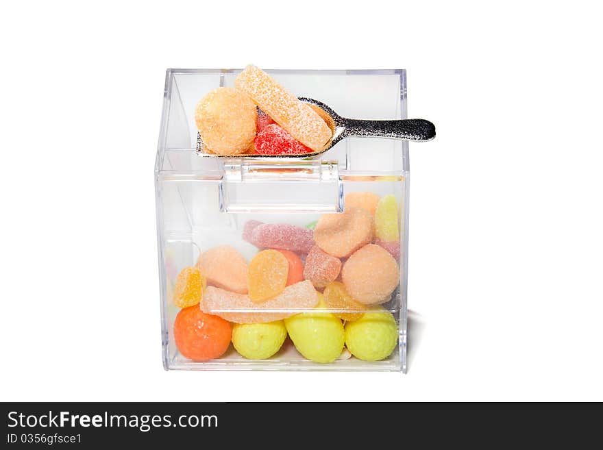 Multi-colored sweets and chewing gums in a transparent box