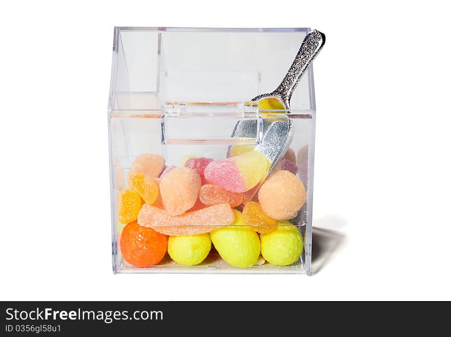 Multi-colored sweets and chewing gums in a transparent box