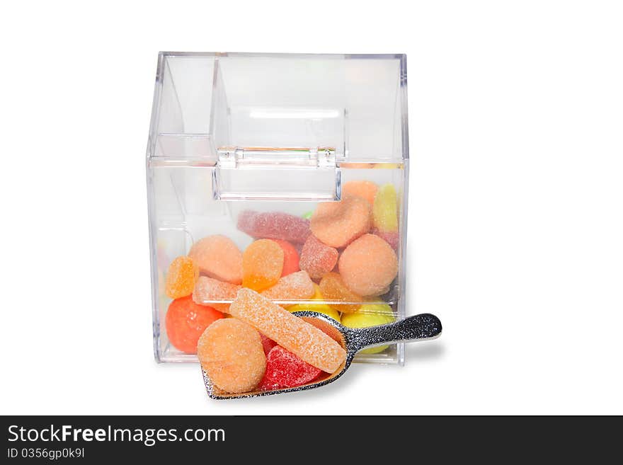 Multi-colored sweets and chewing gums in a transparent box