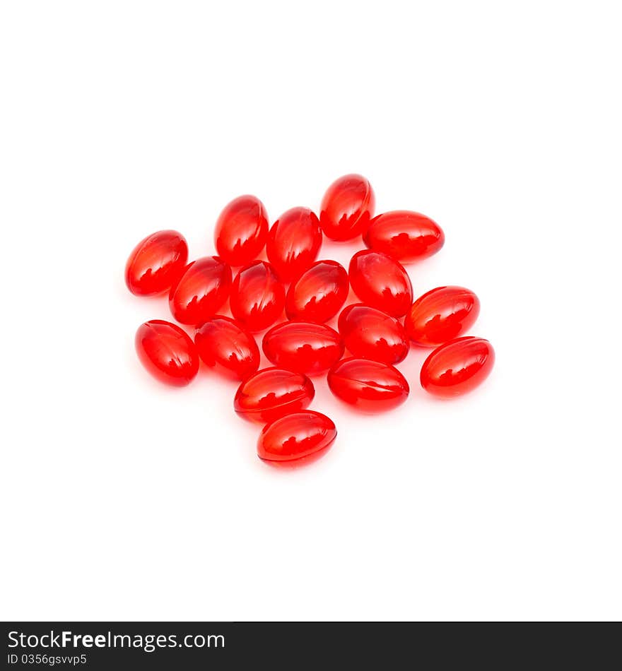 Red pills spilled isolated on white background. Red pills spilled isolated on white background