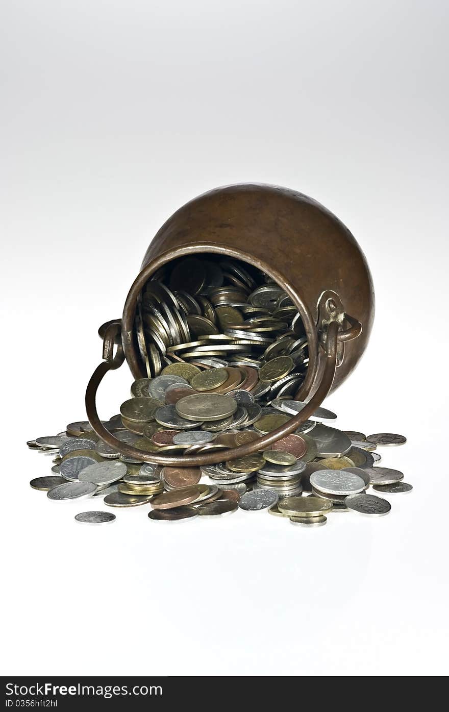 Old copper pot with coins on white. Old copper pot with coins on white