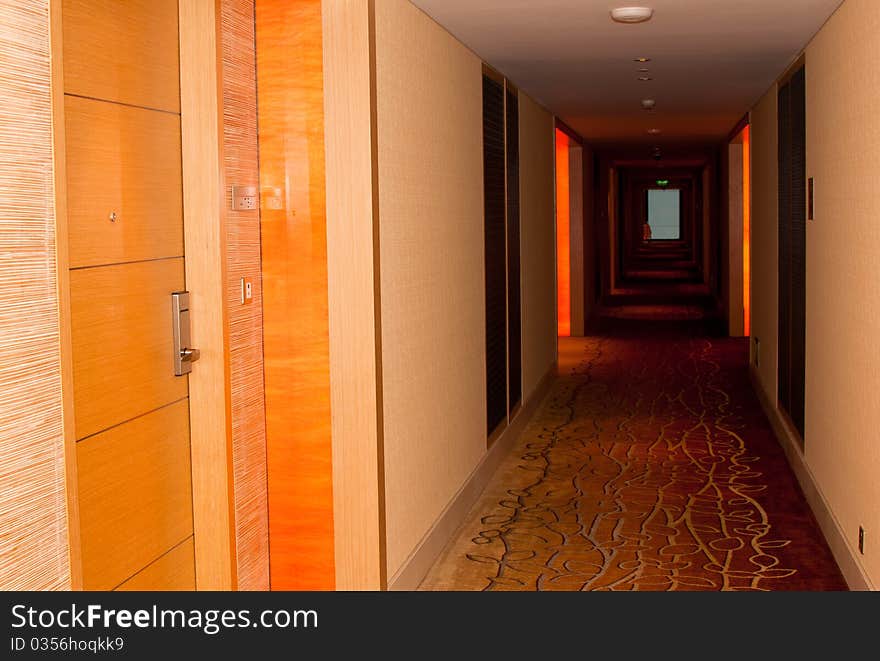 A perspective deep view of a hotel dark hallway. A perspective deep view of a hotel dark hallway