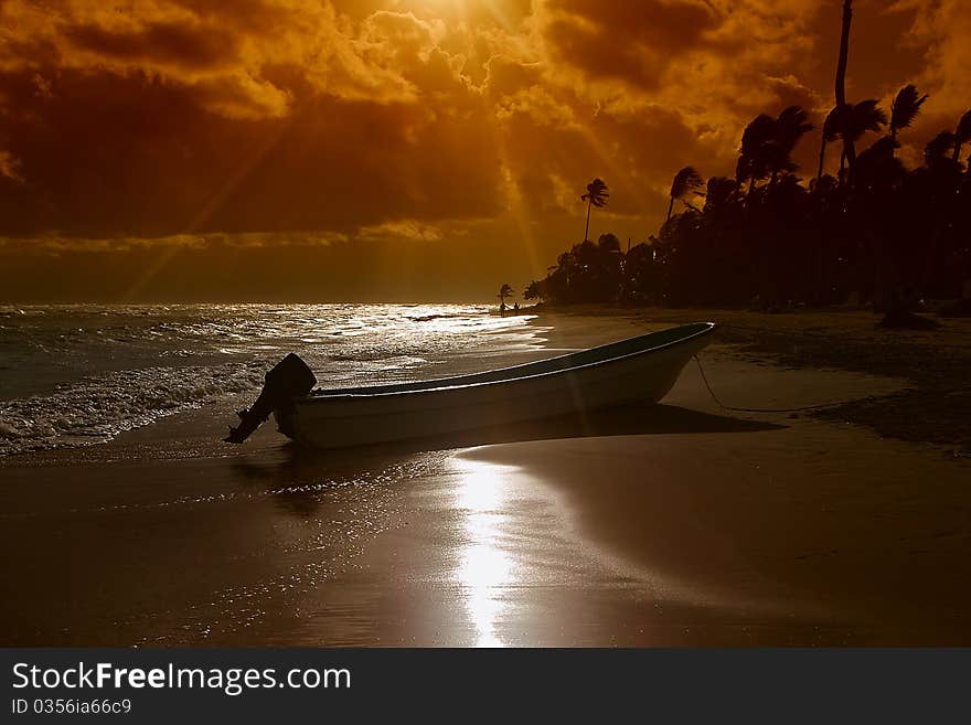 Boat and sunset beach