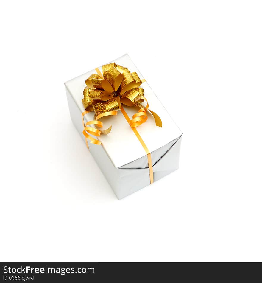 White gift with gold bow isolated on white background