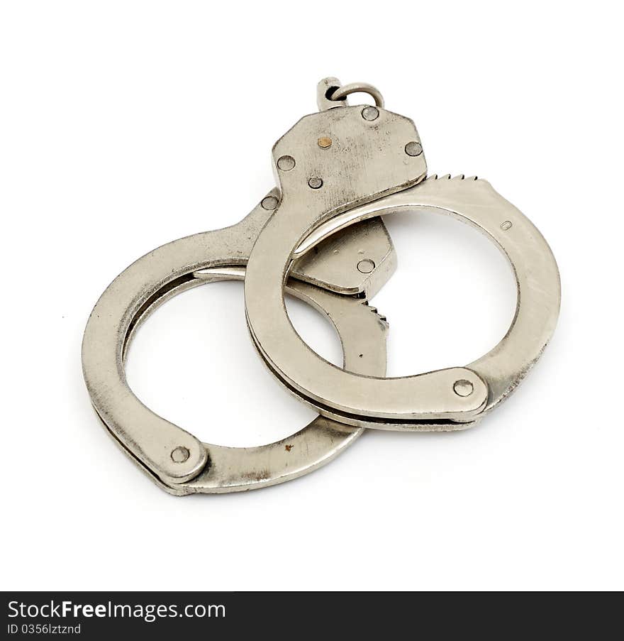 Steel metallic handcuffs (manacles) isolated on white background