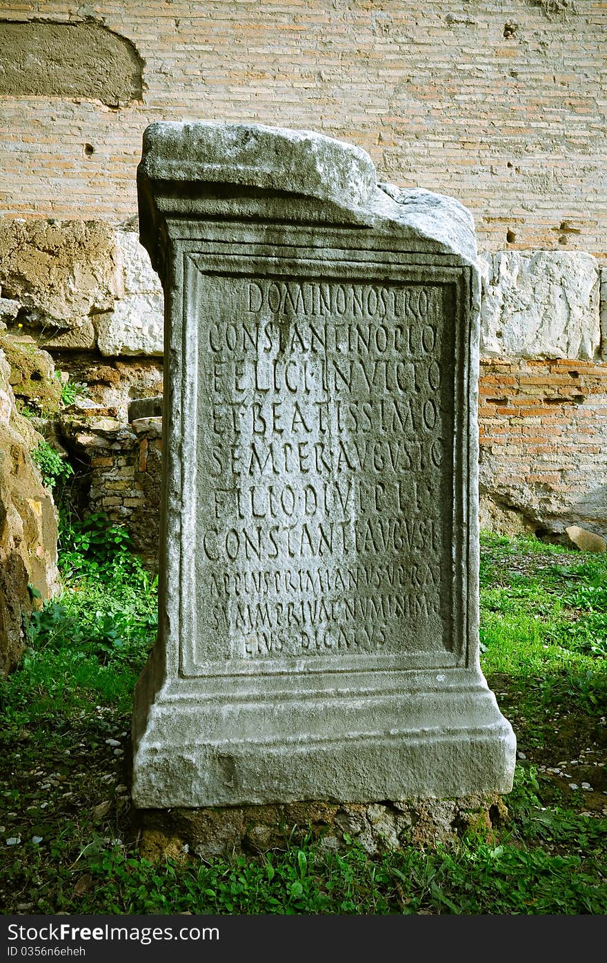 Pillar of stone with ancient Roman writings in Roman Forum, Rome, Italy.