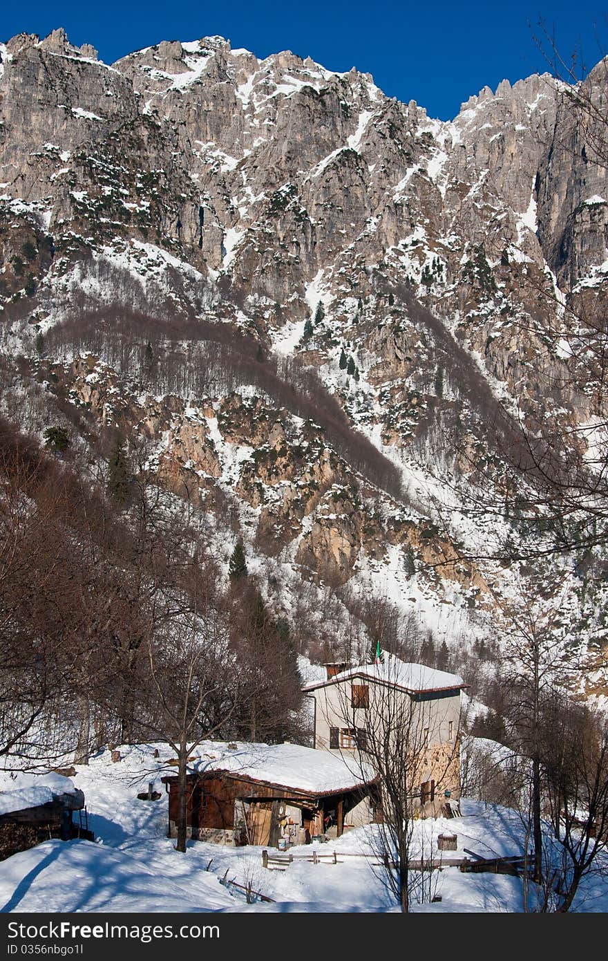 A beautiful landscape with snow covered mountains in a cold winter day. A beautiful landscape with snow covered mountains in a cold winter day