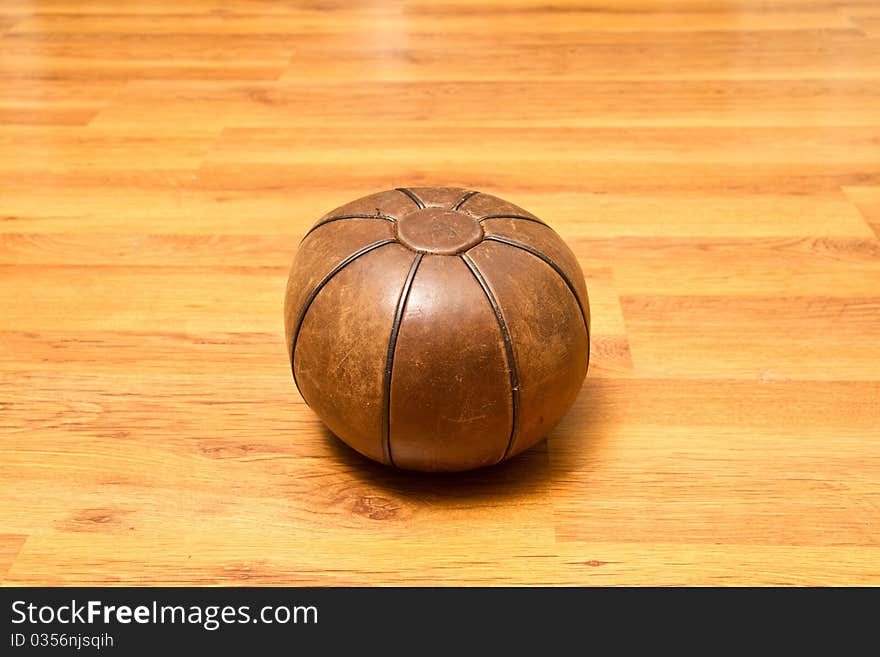 Medicinal leather ball on the gym floor