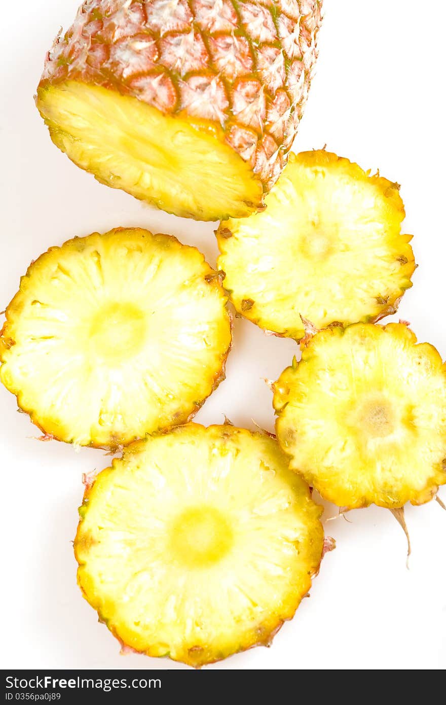 Cut pineapple isolated on white background