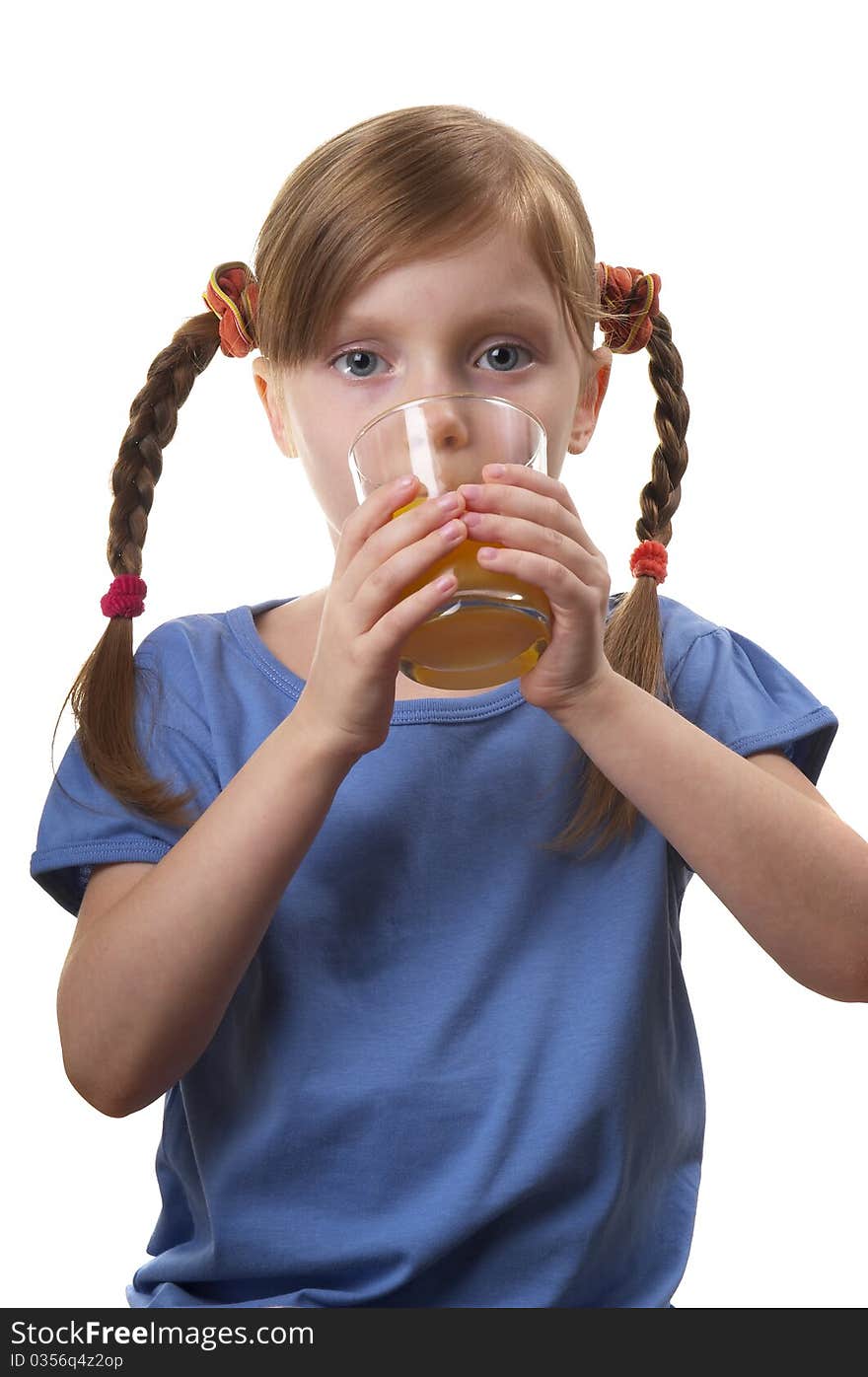 Young funny girl with a glass of juice over white background