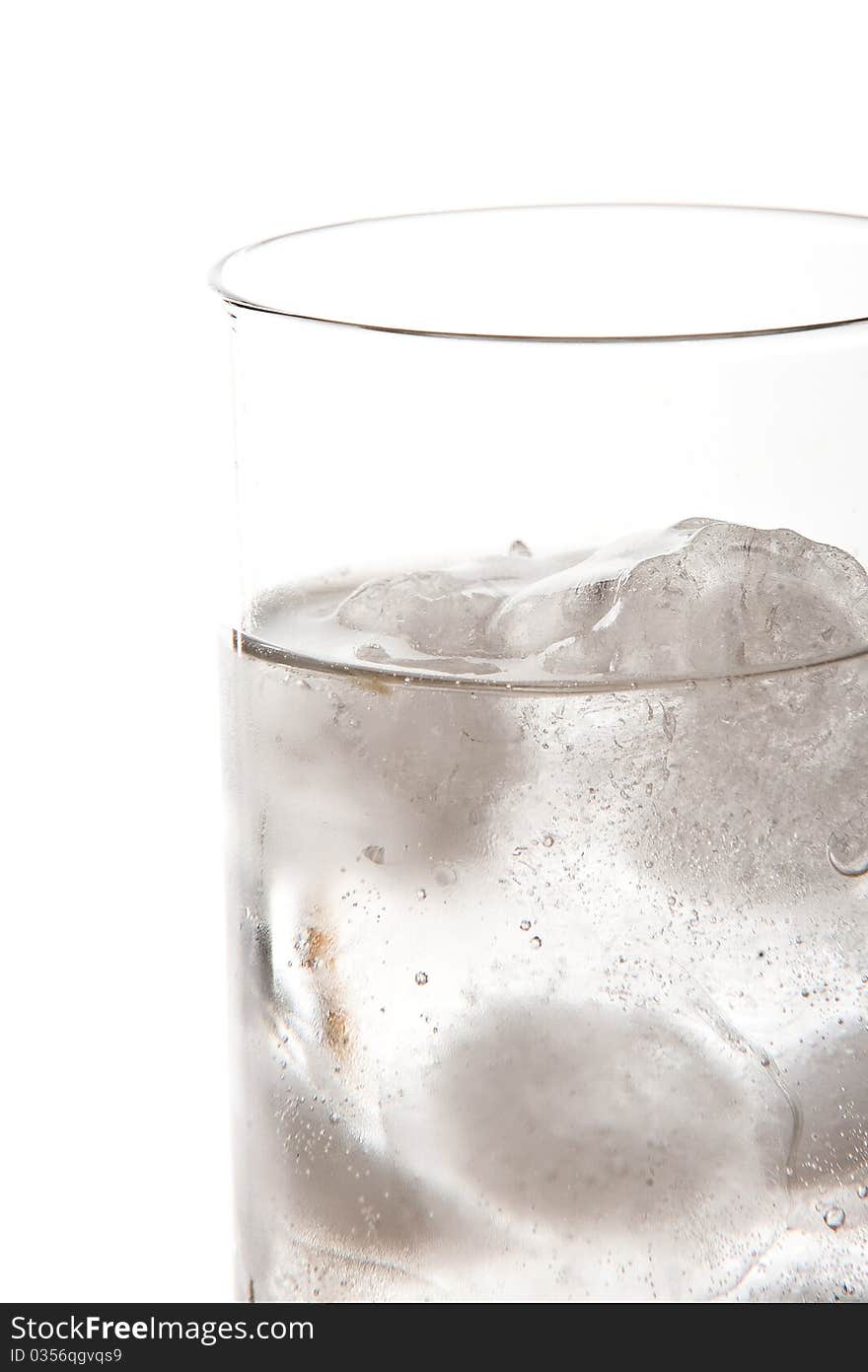 Isolated glass of soda with ice cold water on a white background