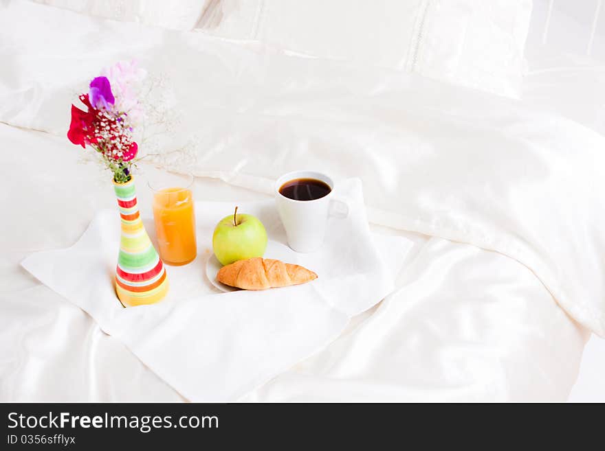 Cup of coffe and flower in vase on tray. Cup of coffe and flower in vase on tray