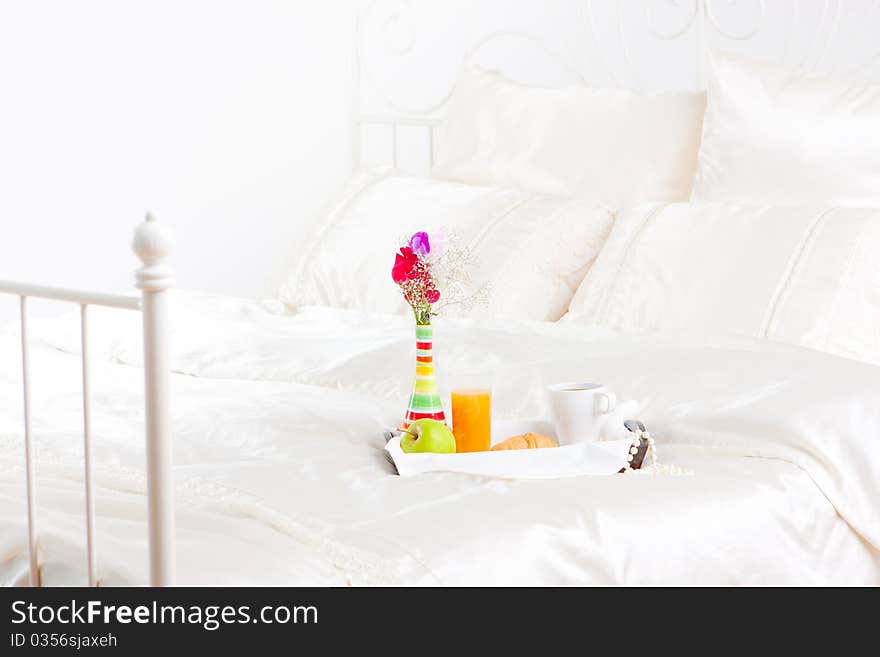 Cup of coffe and flower in vase on tray. Cup of coffe and flower in vase on tray