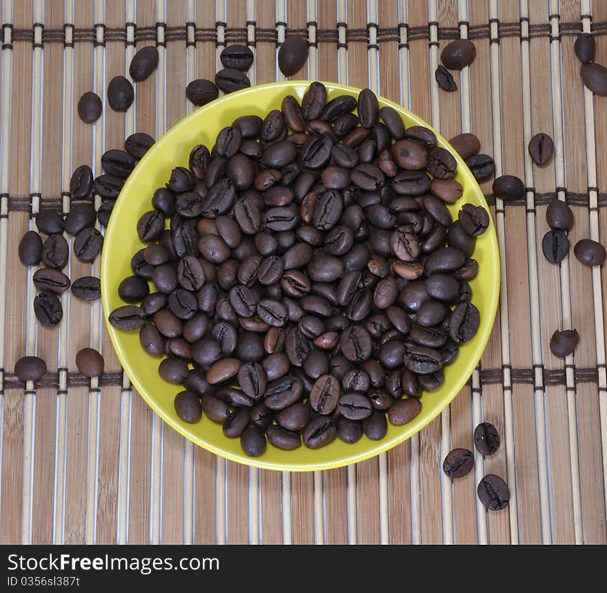 Grains of coffee are in a saucer