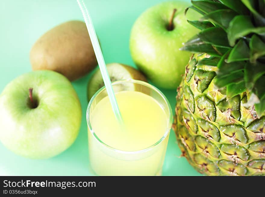 Juice and fruit on light background