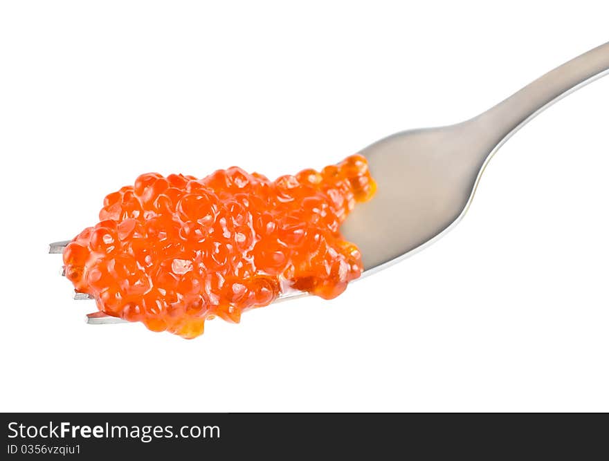 Red caviar on a fork isolated on white background