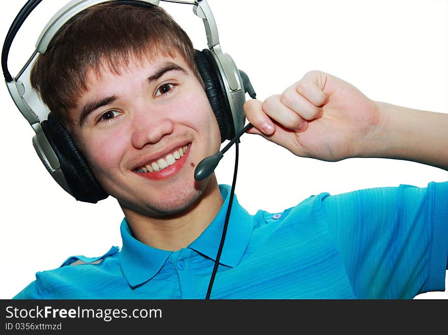 Attractive young man in a blue T-shirt with headphones isolated on white. Attractive young man in a blue T-shirt with headphones isolated on white