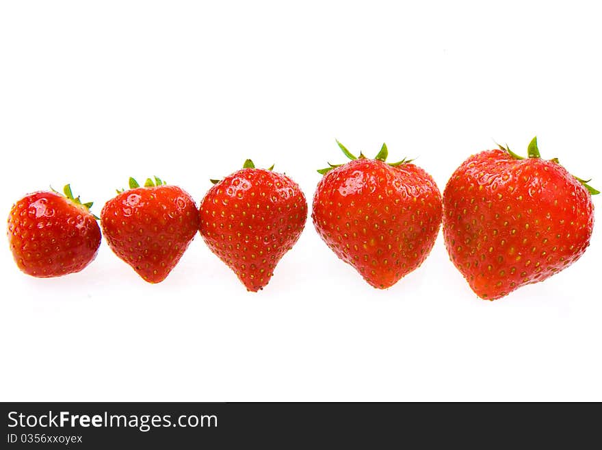 Group of fresh isolated strawberries on a white background