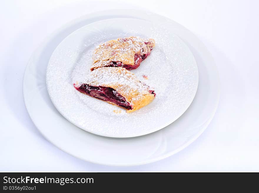 Sour cherry strudel in white plate