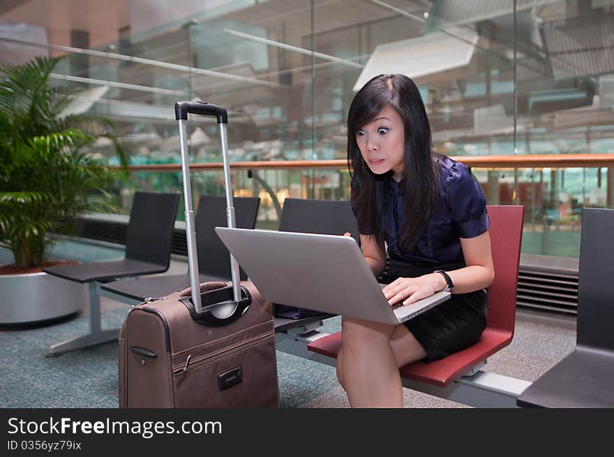 Asian Lady Staring Wide Eyed Into Her Computer