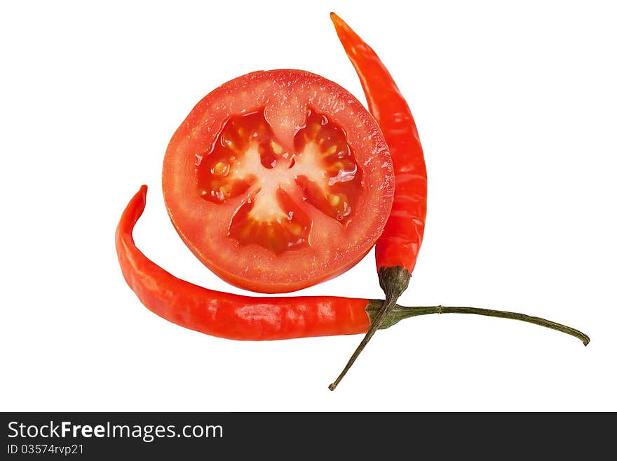 Sliced tomato and two chili peppers isolated on white background