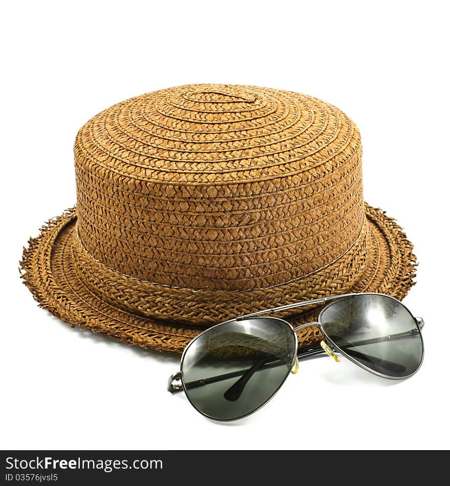 Straw hat and sunglasses isolated on a white background