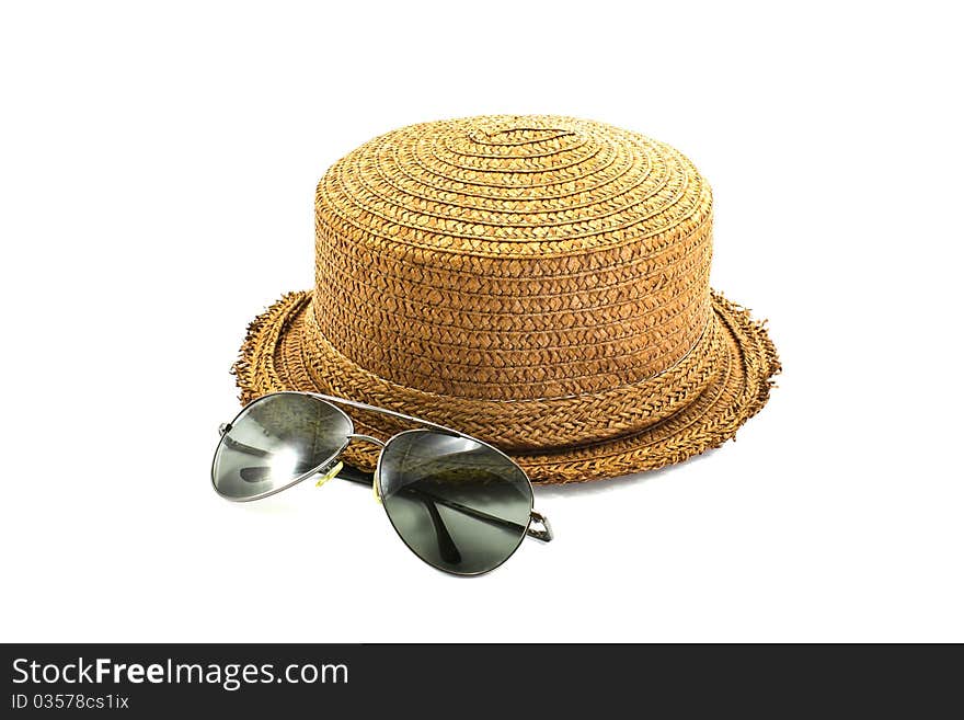 Straw hat and sunglasses isolated on a white background