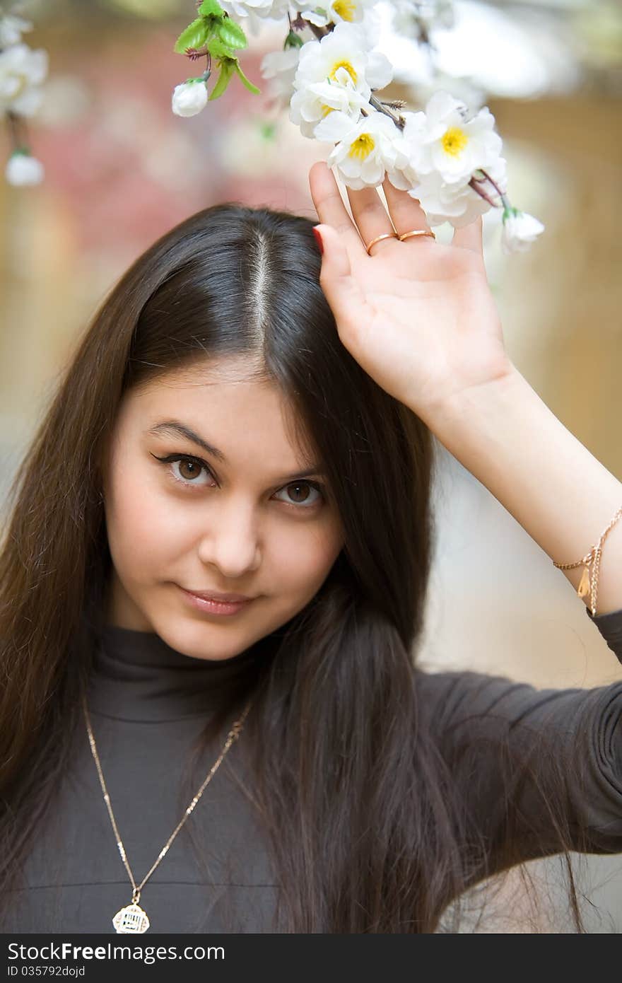 Beautiful Asian girl near a flowering apple tree