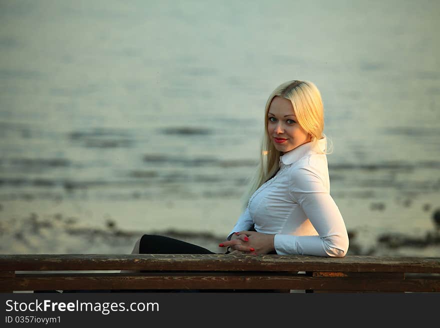 Woman portrait lake on background