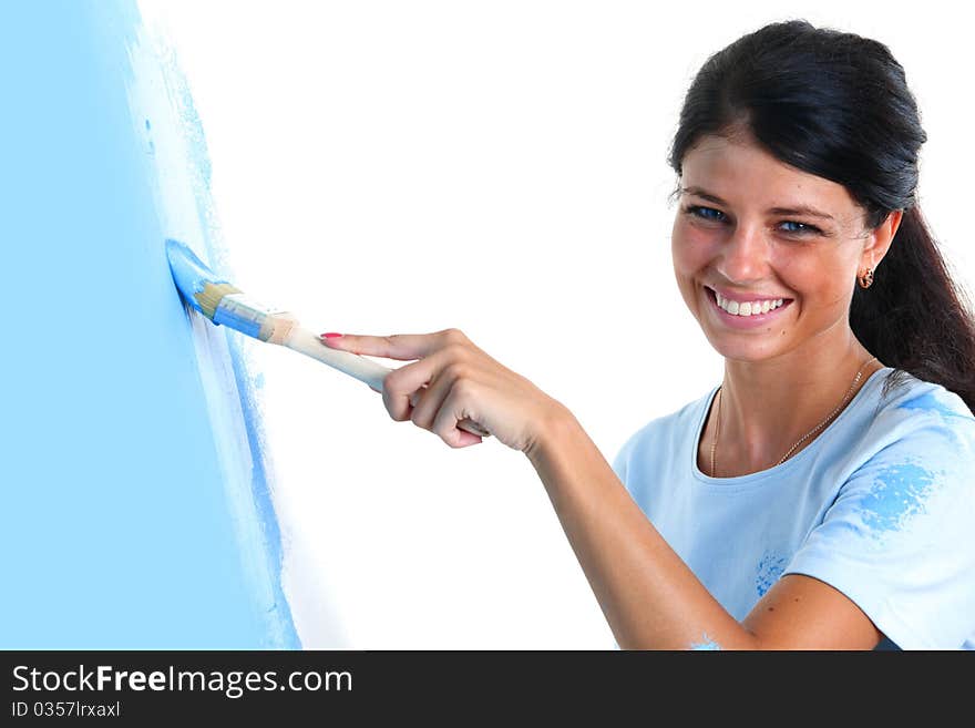 Woman paints the wall brush. Woman paints the wall brush